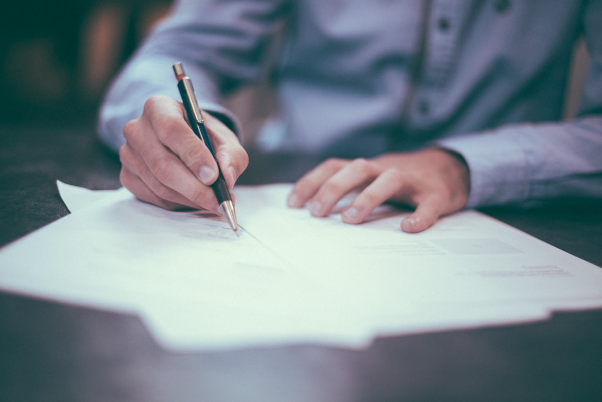 Person analyzing financial documents at a desk